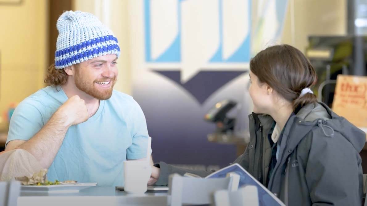 A photo of two people talking