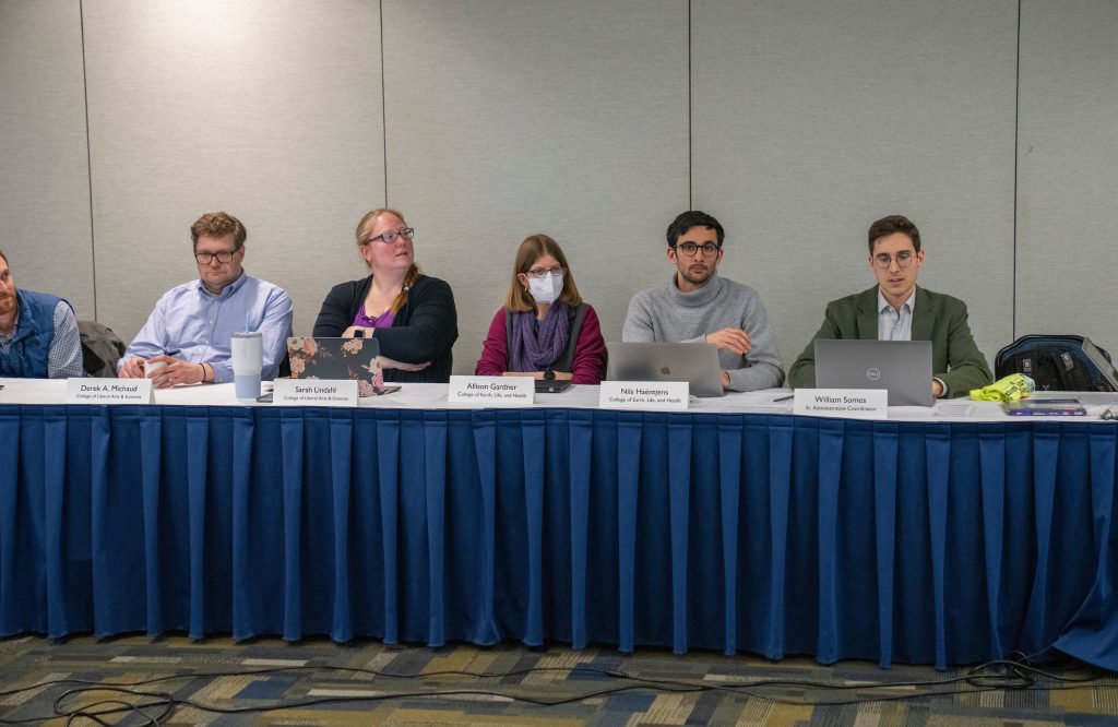 Photo facing senators and the administrative specialist at an open senate meeting.