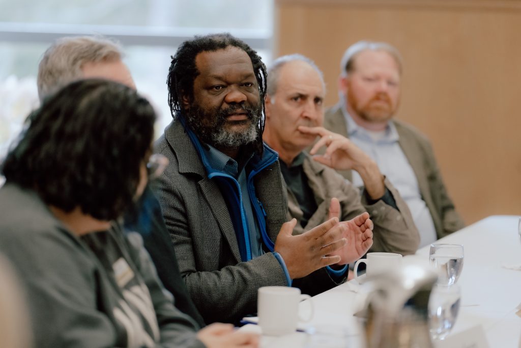 Photo of Henri Akono at an Executive Committee meeting with the Chancellor