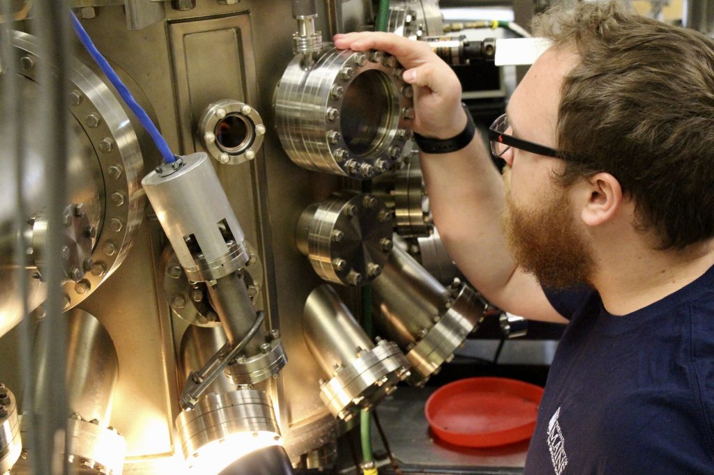 Researcher monitoring the growth of thin film sample