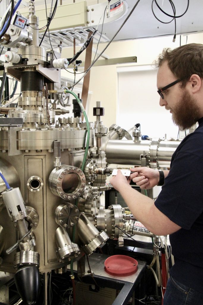 Researcher preparing sample for thin film growth