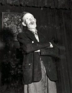 P00256: John Holland at the microphone at the Miramichi Folksong Festival in 1958.