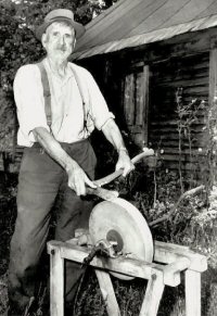 Photo of a Jonathan Moss of Orford, NH sharpening an axe