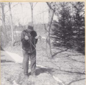 P0732: Elderly man dowsing with same basic method as Kenneth Merrill used; Ralph Thornton, Topsfield, Maine, fall 1973.