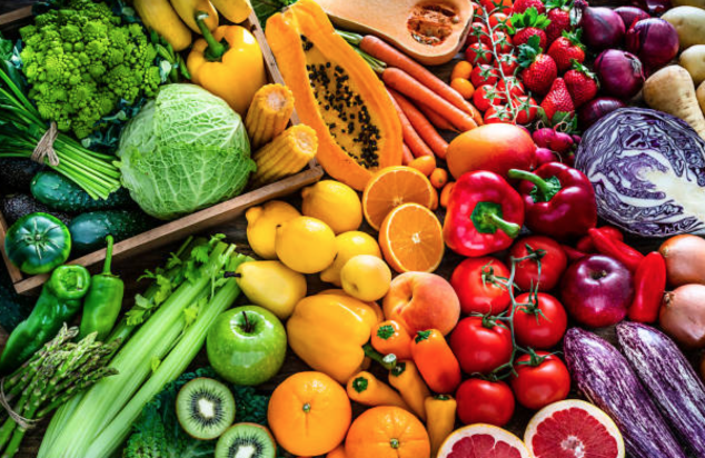 diverse arrangement of healthy foods ranging in colors and sizes