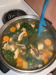 Pot full of chicken and vegetable soup