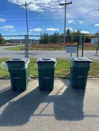 picture of three composting bins standing in a row