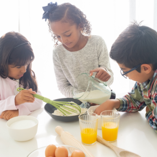 Photo of three children cooking together