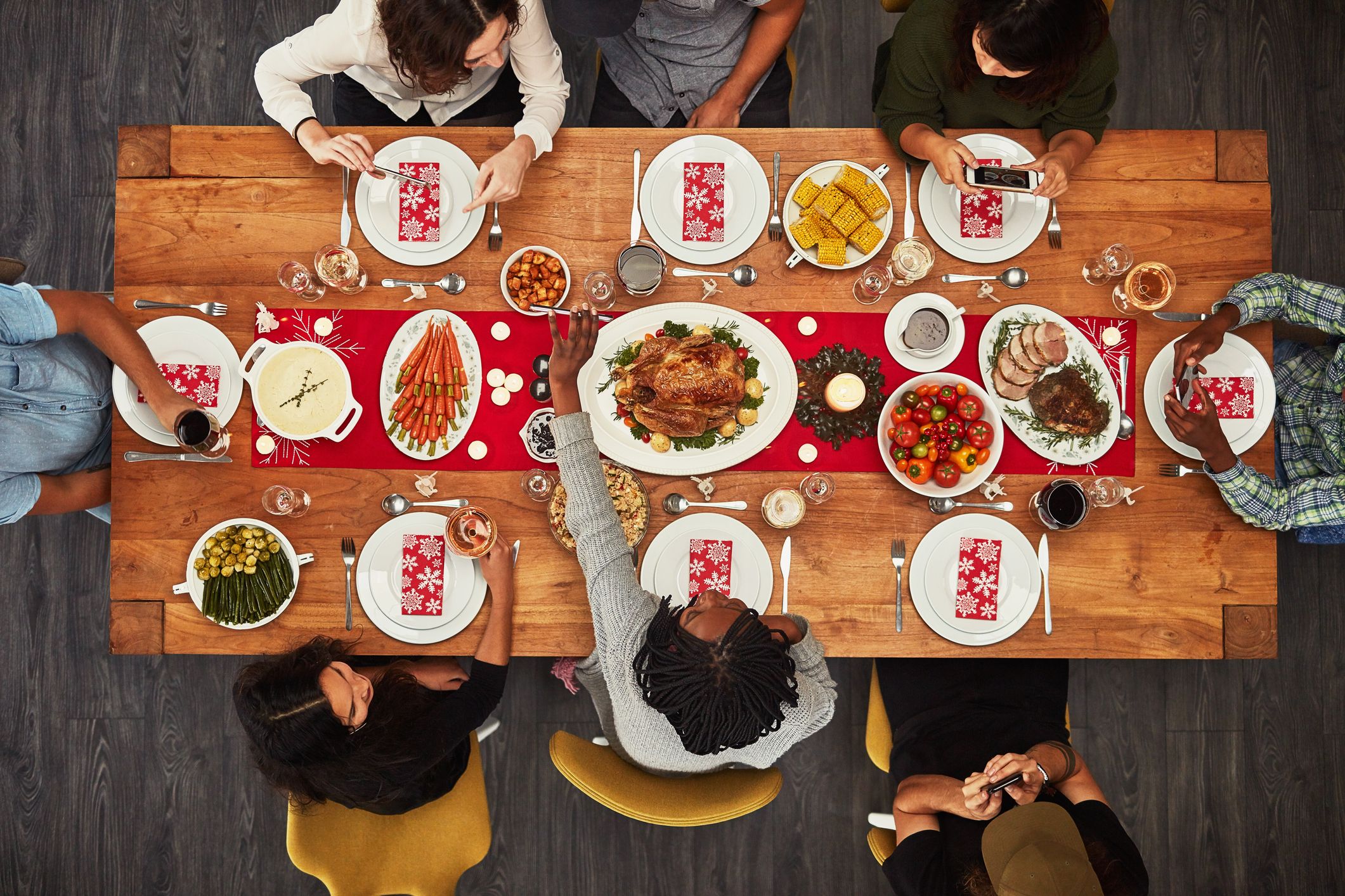 Photo of people sitting around a table, eating traditional holiday foods