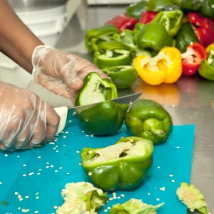 Close up of person cutting up peppers