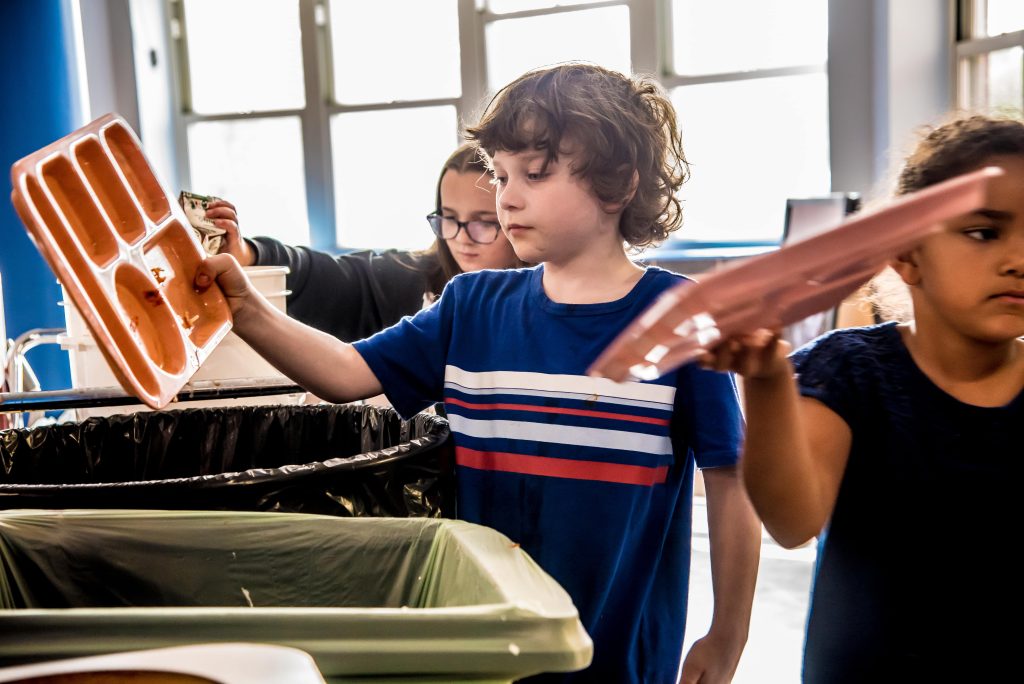 A student participates in sorting his food waste at Lisbon Community School.