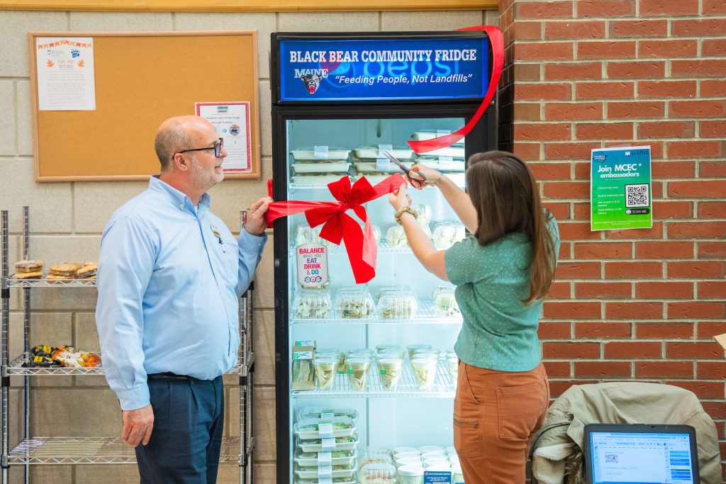 Kate Flynn cutting ribbon on community fridge