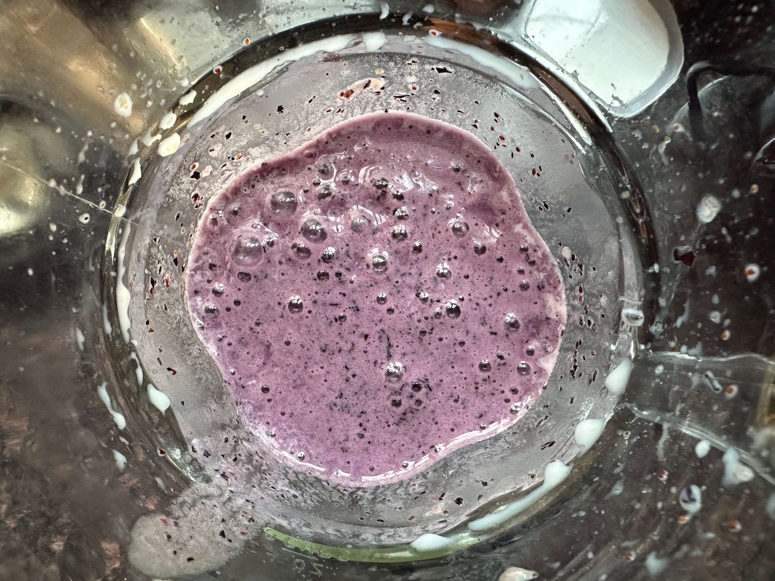 Overhead view of a purple smoothie in the blender