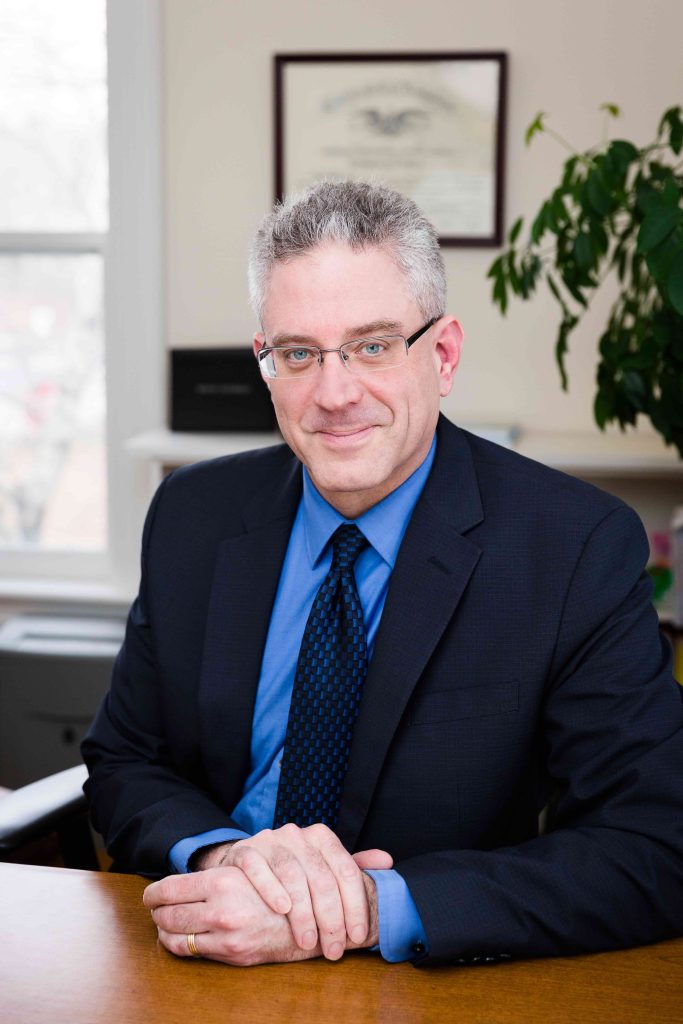 Photo of Andy Wischl sitting at desk