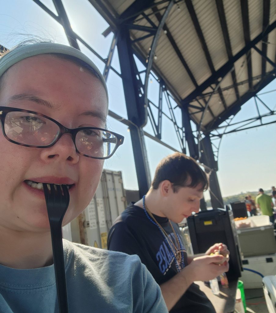 A photo of a woman with a fork in her mouth
