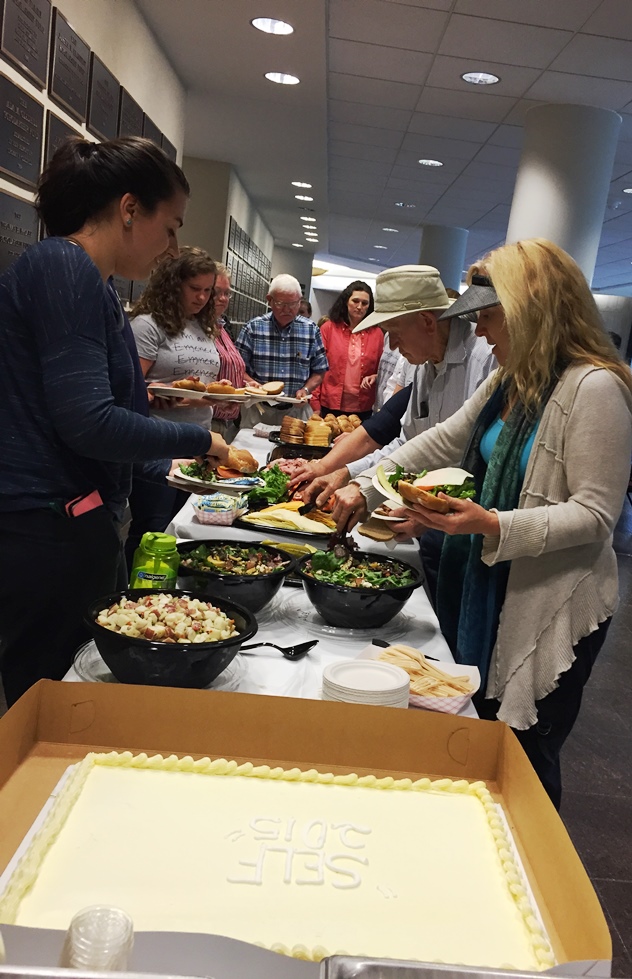 People grabbing some lunch from a Buffet