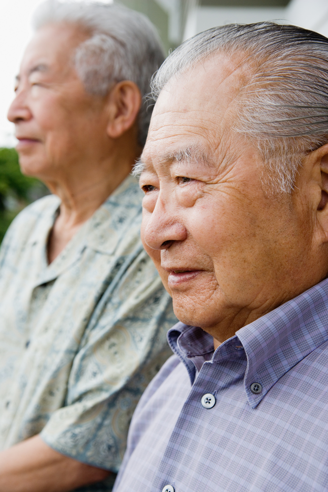 Elderly men sitting side by side