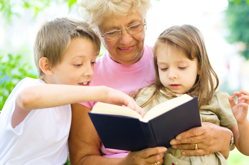 Elderly woman reading to children