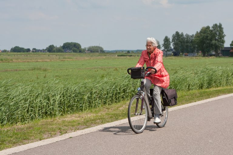 Elderly woman riding bike