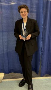 Leah Cingranelli holding the Dr. Susan J. Hunter Presidential Research Impact Award
