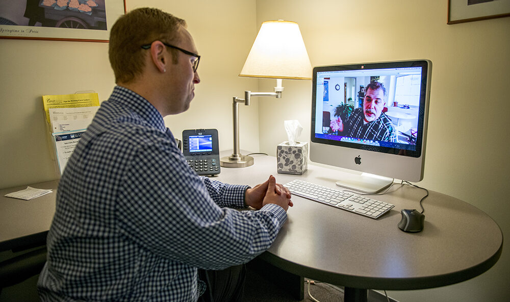 Person having a video chat with some else at their desk