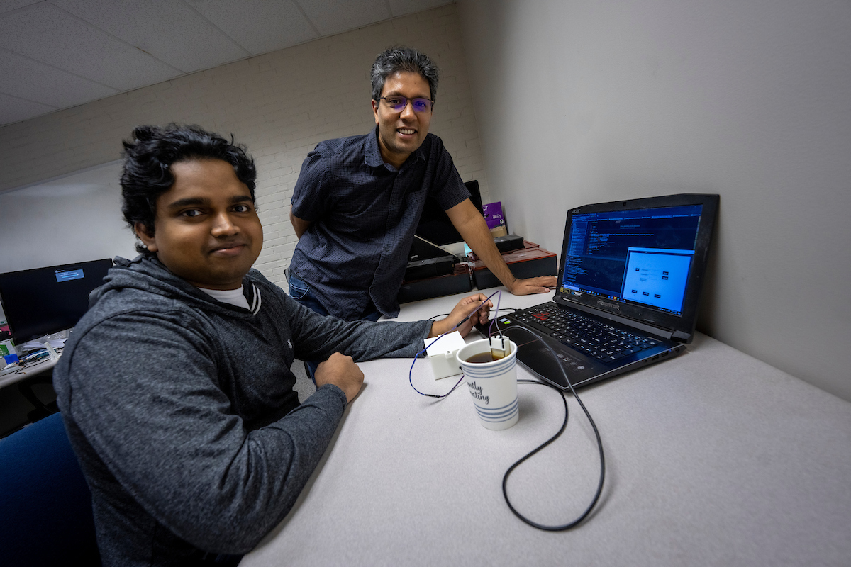 Nimesha Ranasinghe, Assistant Professor of Spatial Informatics in the School of Engineering and Ph.D. student, Chamath Amarasinghe with a device they developed called SipBit