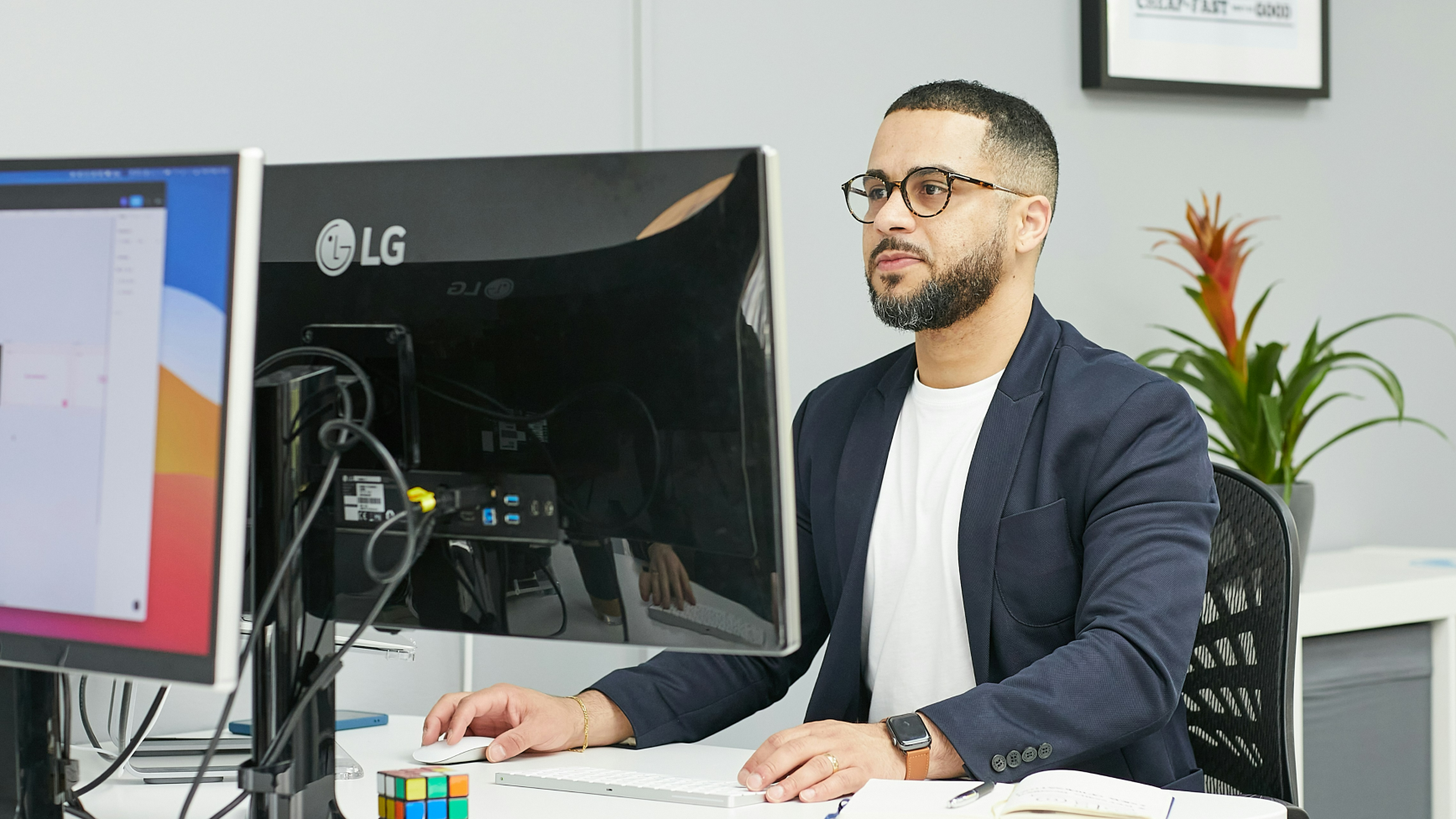 A business student at a computer desk in an office setting