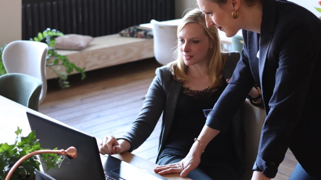 two women looking at laptop together