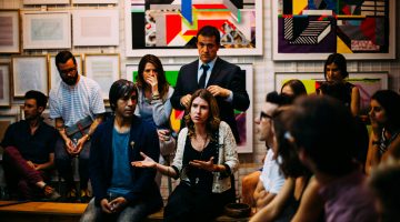 People in a meeting with vibrant art on the walls