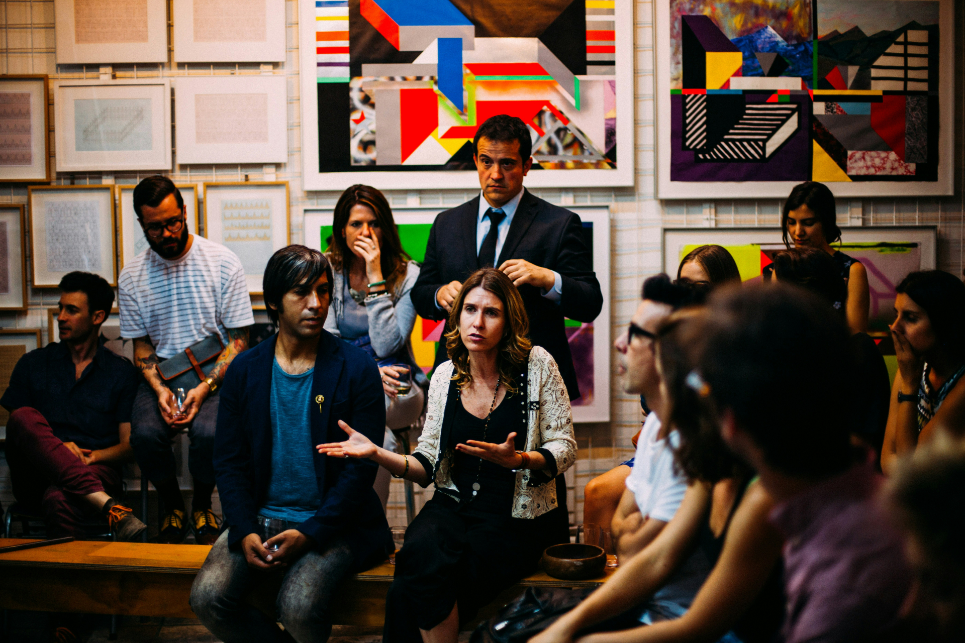 People in a meeting with vibrant art on the walls