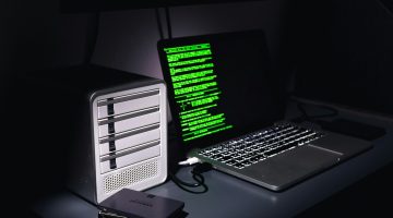 Computer with code on the screen in the dark