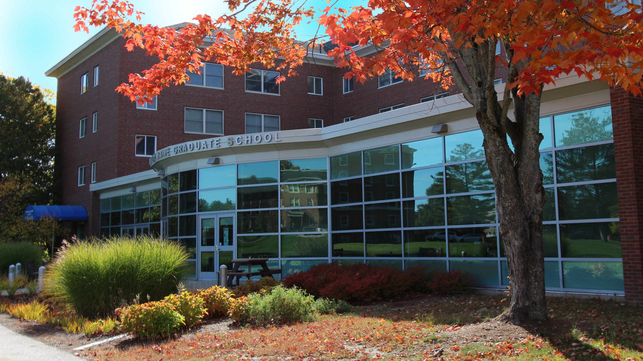 The front of the Graduate School with red fall leaves