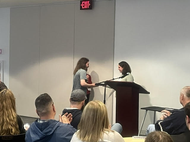 A student receiving an award