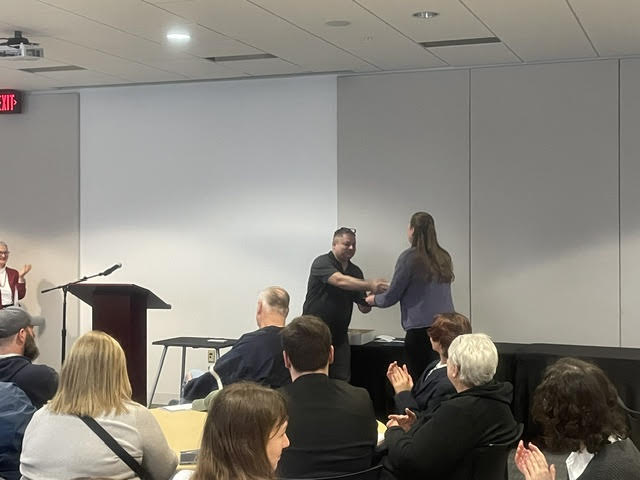 A student receiving an award