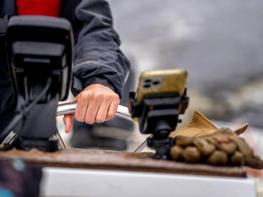 A photo of Lauren Ross' hand on the throttle of a boat