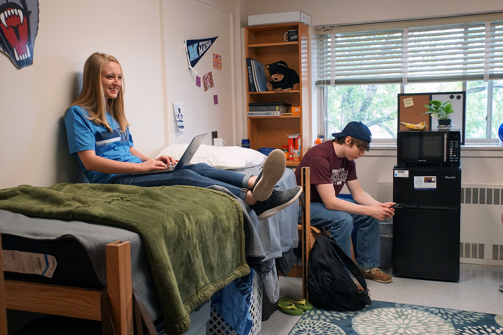 Housing residence life student with mid loft bed