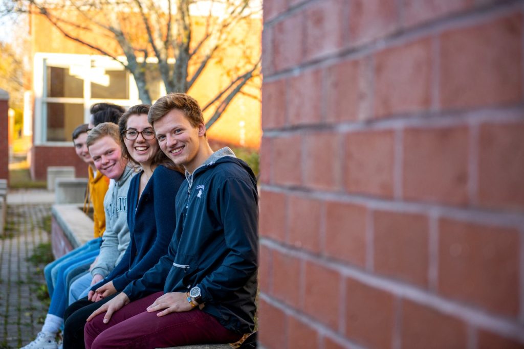 Happy students sitting on campus