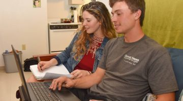 A male and female student studying on a couch in Patch Hall