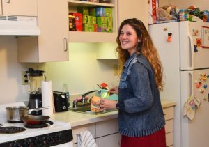 Happy student using kitchen in Patch Hall