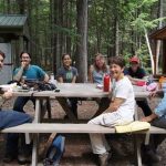 Researchers eating lunch on the picnic table at Howland