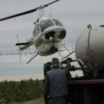 A helicopter takes to the air to fertilize a portion of Howland Forest with nitrogen