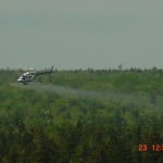 Helicopter spraying nitrogen fertilizer