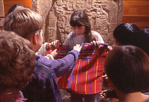 Students examine traditional Maya clothing