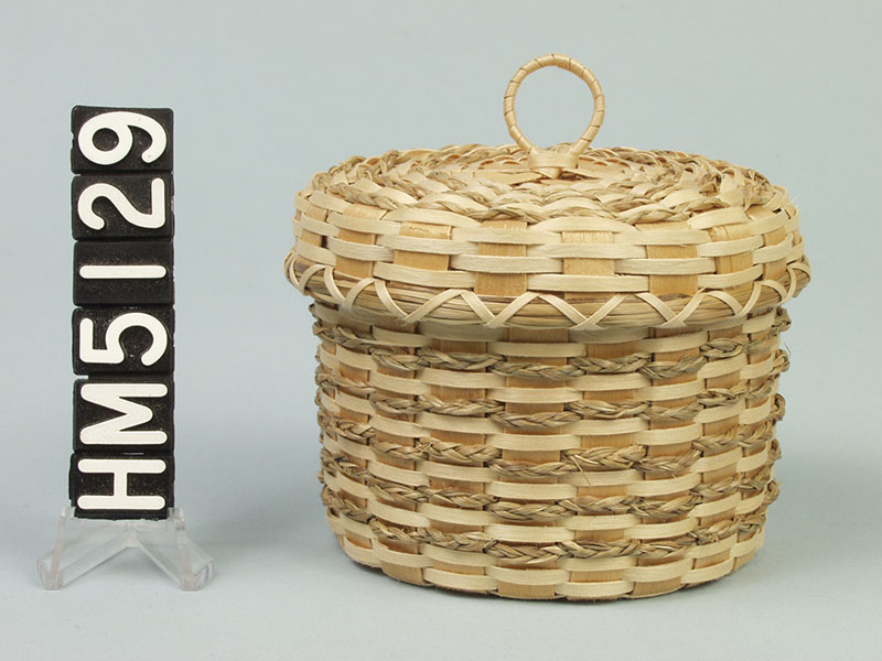 Image of small basket with braided sweetgrass weavers.