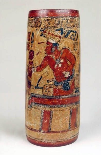 Tall, narrow ceramic vase with painted design of a figure with headdress, necklace, and jaguar leggings.