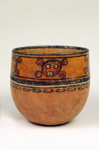 Bowl or wide vase with rounded bottom and walls slightly contracted at top. Orange slip painted with red, black, and white. A stylized head in a band in the upper section of vase. A thick black line and a thin black line surround the rim. Beneath heads and encircling vase are a thin black line, an orange line, a thick black line, a white line, and a black line. The bottom half of the vase is figureless.