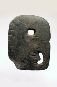 A carved mayan Hatcha. A Stone medallion which resembles the profile of a face. 