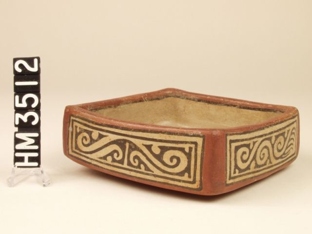 Cocle polychrome square ceramic dish. The four panels on the sides define the vessel as an animal. Double-headed, crested limbed iguana with a boa body, and with animals contained within the boa ovals.