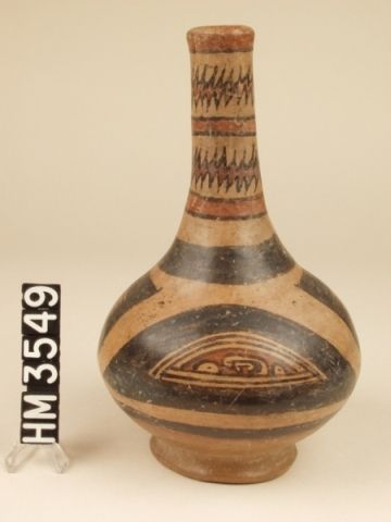 Cocle polychrome ceramic bottle. Calabaza type, Calabaza variety. This tall-necked jar is decorated with abstract head and tail panels as well as Y-element based claws on the side of panel. The jagged bands around the neck of jar refer to the "energy" associated with the boa as life-source or to related natural phenonmenon.