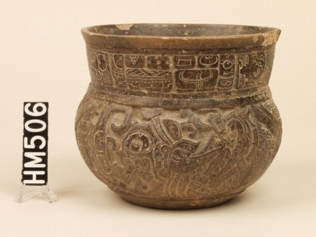 Image of a ceramic bowl with a wide, tall neck. The outside of the vessel is covered in intricate designs.